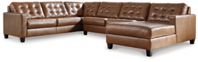 Bask in the beauty of the Baskove sectional. Reserved exclusively for those with an eye for fine contemporary design, this generously scaled sectional in auburn brown is dressed to impress in every way. Real leather throughout the seating area provides incomparable comfort where it counts. Sleek track armrests, tufted box cushions and a sumptuous chaise are the embodiment of luxury.Includes 4 pieces: right-arm facing corner chaise, armless loveseat, left-arm facing loveseat and wedge | "Left-arm" and "right-arm" describe the position of the arm when you face the piece | Corner-blocked frame  | Attached back and loose seat cushions | High-resiliency foam cushions wrapped in thick poly fiber | Leather interior upholstery; vinyl/polyester upholstery | Exposed feet with faux wood finish | Platform foundation system resists sagging 3x better than spring system after 20,000 testing cycles by providing more even support | Smooth platform foundation maintains tight, wrinkle-free look without dips or sags that can occur over time with sinuous spring foundations | Estimated Assembly Time: 15 Minutes