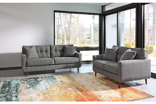 Feed your mid-century modern nostalgia with a contemporary twist in the Zardoni sofa. Colored in an attractive gray, it’s upholstered in a timeless texture. Classic tufted back and tapered peg legs are a nice revival. Linear profile with two toss pillows adds plenty of fresh style, perfect for small spaces.Corner-blocked frame | Attached back and loose seat cushions | High-resiliency foam cushions wrapped in thick poly fiber | 2 decorative pillows included | Pillows with soft polyfill | Polyester upholstery and pillows | Exposed feet with faux wood finish | Excluded from promotional discounts and coupons