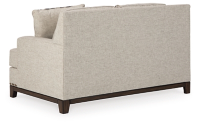 With its uniquely chic blend of elements, the Ballina loveseat breaks the rules in a beautiful way. Crisp and clean—with just a hint of classic flair—this designer loveseat stands out with its sleek track arms and prominent nailhead trim punctuating the linear profile. Truly setting this contemporary loveseat apart—an exposed walnut-tone rail for a high-end, furniture gallery aesthetic. Reversible cushions and decorative pillows in relaxed, muted hues make this loveseat befitting everything from modern farmhouse to urban chic spaces.Corner-blocked frame | Reversible cushions | High-resiliency foam cushions wrapped in thick poly fiber | Polyester upholstery | Throw pillows included | Pillows with soft polyfill | Exposed rail and feet with faux wood finish | Platform foundation system resists sagging 3x better than spring system after 20,000 testing cycles by providing more even support | Smooth platform foundation maintains tight, wrinkle-free look without dips or sags that can occur over time with sinuous spring foundations