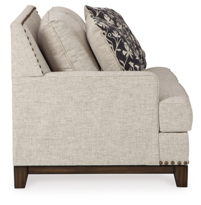 With its uniquely chic blend of elements, the Ballina loveseat breaks the rules in a beautiful way. Crisp and clean—with just a hint of classic flair—this designer loveseat stands out with its sleek track arms and prominent nailhead trim punctuating the linear profile. Truly setting this contemporary loveseat apart—an exposed walnut-tone rail for a high-end, furniture gallery aesthetic. Reversible cushions and decorative pillows in relaxed, muted hues make this loveseat befitting everything from modern farmhouse to urban chic spaces.Corner-blocked frame | Reversible cushions | High-resiliency foam cushions wrapped in thick poly fiber | Polyester upholstery | Throw pillows included | Pillows with soft polyfill | Exposed rail and feet with faux wood finish | Platform foundation system resists sagging 3x better than spring system after 20,000 testing cycles by providing more even support | Smooth platform foundation maintains tight, wrinkle-free look without dips or sags that can occur over time with sinuous spring foundations