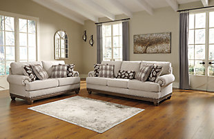 True classic character comes to life in the Harleson loveseat. Set back pleated rolled arms and warm brown exposed frame with bun feet are beautifully traditional. Lovely detailing carries itself through the herringbone weave in the soft upholstery. Seat cushions reverse to maintain durable comfort. Vintage-inspired jumbo nailhead trim graces the design. Plaid and botanical pillows in dark brown are a timeless touch.Corner-blocked frame | Attached back and reversible seat cushions | High-resiliency foam cushions wrapped in thick poly fiber | 4 decorative pillows included | Pillows with soft polyfill | Polyester upholstery; Polyester/acrylic/linen and polyester pillows | Bronze-tone nailhead trim | Exposed feet with faux wood finish | Platform foundation system resists sagging 3x better than spring system after 20,000 testing cycles by providing more even support | Smooth platform foundation maintains tight, wrinkle-free look without dips or sags that can occur over time with sinuous spring foundations