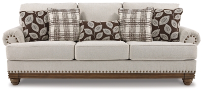 True classic character comes to life in the Harleson sofa. Set back pleated rolled arms and warm brown exposed frame with bun feet are beautifully traditional. Lovely detailing carries itself through the herringbone weave in the soft upholstery. Seat cushions reverse to maintain durable comfort. Vintage-inspired jumbo nailhead trim graces the design. Plaid and botanical pillows in dark brown are a timeless touch.Corner-blocked frame | Attached back and reversible seat cushions | High-resiliency foam cushions wrapped in thick poly fiber | 5 decorative pillows included | Pillows with soft polyfill | Polyester upholstery; Polyester/acrylic/linen and polyester pillows | Bronze-tone nailhead trim | Exposed feet with faux wood finish | Platform foundation system resists sagging 3x better than spring system after 20,000 testing cycles by providing more even support | Smooth platform foundation maintains tight, wrinkle-free look without dips or sags that can occur over time with sinuous spring foundations