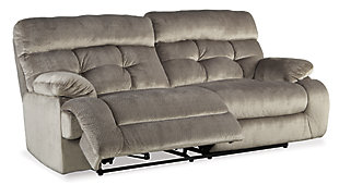 Double up on style and comfort with the Brassville reclining sofa and loveseat. Wondery wide seats are upholstered in a textural, cottony soft fabric. Recline as far back as you please on pillowy arms and headrests. Bustle back tufting adds the right amount of casually cool style.Includes reclining sofa and reclining loveseat with console | Dual-sided recliners | Pull tab reclining motion | Corner-blocked frame with metal reinforced seats | Attached back and seat cushions | High-resiliency foam cushions wrapped in thick poly fiber | Loveseat with lift-top storage console and 2 cup holders | Polyester upholstery