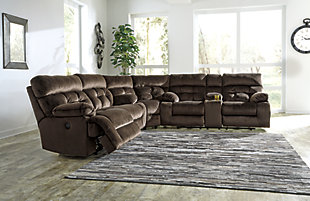 A large scale means large comfort with the Brassville 3-piece sectional with power. Wonderfully wide seats are upholstered in a textural, cottony soft fabric. Recline as far back as you please on pillowy arms and headrests at one easy touch of a button. Bustle back tufting adds the right amount of casually cool style. With a storage console and two convenient cup holders, you’ll want to stay here forever.Includes 3 pieces: 2-seat reclining power sofa, wedge and double reclining power loveseat with console | Power reclining sofa and power reclining loveseat with one-touch power control with adjustable positions | Console with storage and 2 cup holders | Corner-blocked frame with metal seat | Attached back and seat cushions | High-resiliency foam cushions wrapped in thick poly fiber | Polyester upholstery | Power cord included; UL Listed | Estimated Assembly Time: 10 Minutes