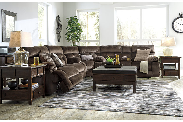 A large scale means large comfort with the Brassville 3-piece sectional with power. Wonderfully wide seats are upholstered in a textural, cottony soft fabric. Recline as far back as you please on pillowy arms and headrests at one easy touch of a button. Bustle back tufting adds the right amount of casually cool style. With a storage console and two convenient cup holders, you’ll want to stay here forever.Includes 3 pieces: 2-seat reclining power sofa, wedge and double reclining power loveseat with console | Power reclining sofa and power reclining loveseat with one-touch power control with adjustable positions | Console with storage and 2 cup holders | Corner-blocked frame with metal seat | Attached back and seat cushions | High-resiliency foam cushions wrapped in thick poly fiber | Polyester upholstery | Power cord included; UL Listed | Estimated Assembly Time: 10 Minutes