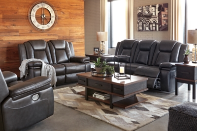 Wouldn’t it be great if the cool look of leather could be blended with the warm feel of fabric? Find a beautiful balance of contemporary style and cozy comfort in the Garristown power reclining sofa. Sporting a sultry gray UltraPella fabric, this chic faux leather sofa is empowering in every which way. The Easy View™ power headrest allows you the perfect view of the TV, even when you’re lying back. And if you’re never far from your cell phone or laptop, you’ll surely appreciate the one-touch power control with USB charging port.Dual-sided recliner; middle seat stays stationary | One-touch power control with adjustable positions | Corner-blocked frame with wooden seat box | Attached back and seat cushions | High-resiliency foam cushions wrapped in thick poly fiber | Easy View™ power adjustable headrest | Includes USB charging port in the power control | Polyester/polyurethane upholstery | Power cord included; UL Listed | Estimated Assembly Time: 30 Minutes