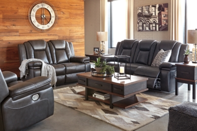 Wouldn’t it be great if the cool look of leather could be blended with the warm feel of fabric? Find a beautiful balance of contemporary style and cozy comfort in the Garristown power reclining sofa. Sporting a sultry gray UltraPella fabric, this chic faux leather sofa is empowering in every which way. The Easy View™ power headrest allows you the perfect view of the TV, even when you’re lying back. And if you’re never far from your cell phone or laptop, you’ll surely appreciate the one-touch power control with USB charging port.Dual-sided recliner; middle seat stays stationary | One-touch power control with adjustable positions | Corner-blocked frame with wooden seat box | Attached back and seat cushions | High-resiliency foam cushions wrapped in thick poly fiber | Easy View™ power adjustable headrest | Includes USB charging port in the power control | Polyester/polyurethane upholstery | Power cord included; UL Listed | Estimated Assembly Time: 30 Minutes