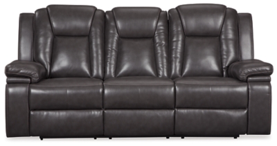 Wouldn’t it be great if the cool look of leather could be blended with the warm feel of fabric? Find a beautiful balance of contemporary style and cozy comfort in the Garristown power reclining sofa. Sporting a sultry gray UltraPella fabric, this chic faux leather sofa is empowering in every which way. The Easy View™ power headrest allows you the perfect view of the TV, even when you’re lying back. And if you’re never far from your cell phone or laptop, you’ll surely appreciate the one-touch power control with USB charging port.Dual-sided recliner; middle seat stays stationary | One-touch power control with adjustable positions | Corner-blocked frame with wooden seat box | Attached back and seat cushions | High-resiliency foam cushions wrapped in thick poly fiber | Easy View™ power adjustable headrest | Includes USB charging port in the power control | Polyester/polyurethane upholstery | Power cord included; UL Listed | Estimated Assembly Time: 30 Minutes