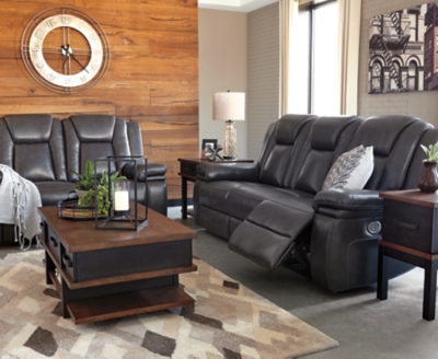 Wouldn’t it be great if the cool look of leather could be blended with the warm feel of fabric? Find a beautiful balance of contemporary style and cozy comfort in the Garristown power reclining sofa. Sporting a sultry gray UltraPella fabric, this chic faux leather sofa is empowering in every which way. The Easy View™ power headrest allows you the perfect view of the TV, even when you’re lying back. And if you’re never far from your cell phone or laptop, you’ll surely appreciate the one-touch power control with USB charging port.Dual-sided recliner; middle seat stays stationary | One-touch power control with adjustable positions | Corner-blocked frame with wooden seat box | Attached back and seat cushions | High-resiliency foam cushions wrapped in thick poly fiber | Easy View™ power adjustable headrest | Includes USB charging port in the power control | Polyester/polyurethane upholstery | Power cord included; UL Listed | Estimated Assembly Time: 30 Minutes