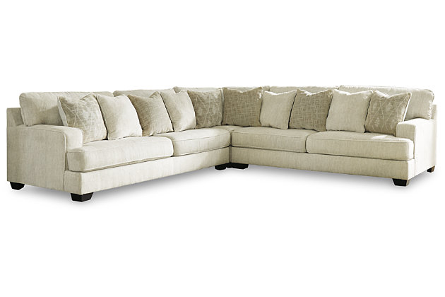 If you love the idea of contemporary style that’s ultra warm and inviting, the Rawcliffe 3-piece sectional with oversized ottoman is casual refinement you’ll love living with. Lightening things up in a fresh neutral tone, this sectional and ottoman set is covered in a decadently soft chenille microfiber that’s love at first touch. Sporting clean lines and wide track arms, the sectional indulges with ultra-deep 45" seats and reversible cushions that are easy to flip and fluff. Firmly cushioned square ottoman multitasks as a footrest and casually cool coffee table.Includes 3-piece sectional (with left-arm facing sofa, right-arm facing sofa and wedge) and oversized ottoman | Left-arm and "right-arm" describe the position of the arm when you face the piece | Corner-blocked frame | Loose, reversible cushions | Firmly cushioned ottoman | High-resiliency foam cushions wrapped in thick poly fiber | 10 accent pillows included | Pillows with soft polyfill | Polyester upholstery and pillows | Exposed feet with faux wood finish | Sectional's smooth platform foundation maintains tight, wrinkle-free look without dips or sags that can occur over time with sinuous spring foundations | Platform foundation system resists sagging 3x better than spring system after 20,000 testing cycles by providing more even support | Estimated Assembly Time: 10 Minutes