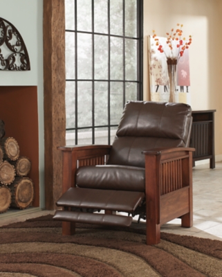 For those on a mission to recline in high style, the high-leg Santa Fe recliner foots the bill. Ruggedly handsome—with a rustic finish, bustle-back plushness and the look of high-grain leather upholstery—this faux leather upholstered piece masters the art of mission-style design. Have the pleasure of reclining without the distraction of a lever or knob.Press-back self-reclining motion | Corner-blocked frame with metal reinforced seat | Attached cushions | High-resiliency foam cushions wrapped in thick poly fiber | Polyurethane upholstery | Exposed frame with faux wood finish | Excluded from promotional discounts and coupons