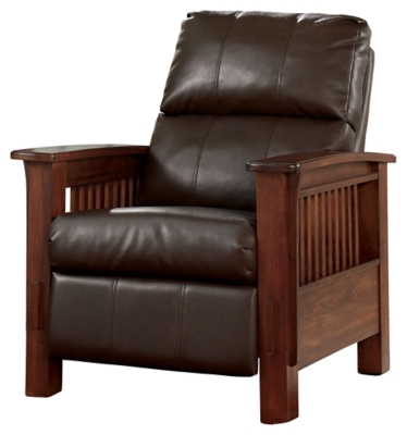 For those on a mission to recline in high style, the high-leg Santa Fe recliner foots the bill. Ruggedly handsome—with a rustic finish, bustle-back plushness and the look of high-grain leather upholstery—this faux leather upholstered piece masters the art of mission-style design. Have the pleasure of reclining without the distraction of a lever or knob.Press-back self-reclining motion | Corner-blocked frame with metal reinforced seat | Attached cushions | High-resiliency foam cushions wrapped in thick poly fiber | Polyurethane upholstery | Exposed frame with faux wood finish | Excluded from promotional discounts and coupons