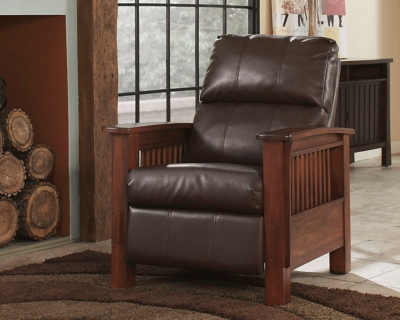 For those on a mission to recline in high style, the high-leg Santa Fe recliner foots the bill. Ruggedly handsome—with a rustic finish, bustle-back plushness and the look of high-grain leather upholstery—this faux leather upholstered piece masters the art of mission-style design. Have the pleasure of reclining without the distraction of a lever or knob.Press-back self-reclining motion | Corner-blocked frame with metal reinforced seat | Attached cushions | High-resiliency foam cushions wrapped in thick poly fiber | Polyurethane upholstery | Exposed frame with faux wood finish | Excluded from promotional discounts and coupons