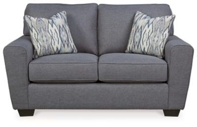 In the chicest shade of gray, Calion loveseat’s linen-weave upholstery complements so many color schemes and aesthetics. Flared arms, prominent welting and flamestitch-print pillows add just enough panache to this sweet and simple loveseat. Supportive seat cushions make for one comfortable landing pad.Corner-blocked frame | Attached back and loose seat cushions | High-resiliency foam cushions wrapped in thick poly fiber | 2 decorative pillows included | Polyester upholstery and pillows with soft polyfill | Exposed feet with faux wood finish | Excluded from promotional discounts and coupons