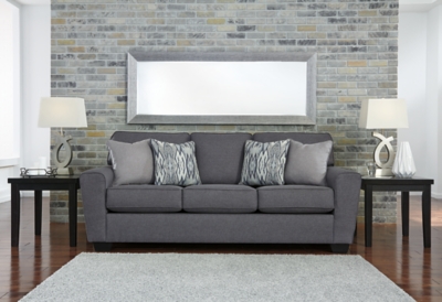 In the chicest shade of gray, Calion sofa’s linen-weave upholstery complements so many color schemes and aesthetics. Flared arms, prominent welting and flamestitch-print pillows add just enough panache to this sweet and simple sofa. Supportive seat cushions make for one comfortable landing pad.Corner-blocked frame | Attached back and loose seat cushions | High-resiliency foam cushions wrapped in thick poly fiber | 4 decorative pillows included | Polyester upholstery and pillows with soft polyfill | Exposed feet with faux wood finish | Excluded from promotional discounts and coupons