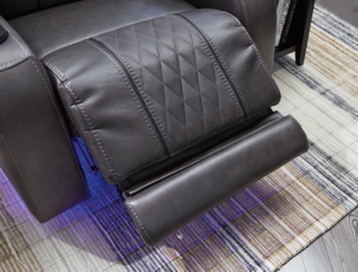 Movie nights will be forever changed with the Composer power recliner. The adjustable Easy View™ headrest allows a primo view of the TV no matter how far back you recline and the extended ottoman provides extra room to really stretch out. Ultra-cool lattice stitching elevates the look and ambient LED lighting completes the theater-style experience. So relax, kick off your shoes and enjoy the show.One-touch power control with adjustable positions | Corner-blocked frame with metal reinforced seat | Attached back and seat cushions | High-resiliency foam cushions wrapped in thick poly fiber | Easy View™ power adjustable headrest | Includes USB charging port in the power control | Extended ottoman for enhanced comfort | Ambient blue LED lighting on cup holders and base for a theater-style experience | Polyester/polyurethane upholstery | Power cord included; UL Listed | Estimated Assembly Time: 15 Minutes