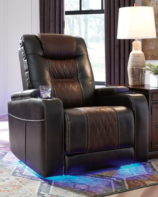 Movie nights will be forever changed with the Composer power recliner. The adjustable Easy View™ headrest allows a primo view of the TV no matter how far back you recline and the extended ottoman provides extra room to really stretch out. Ultra-cool lattice stitching elevates the look and ambient LED lighting completes the theater-style experience. So relax, kick off your shoes and enjoy the show.One-touch power control with adjustable positions | Corner-blocked frame with metal reinforced seat | Attached cushions | High-resiliency foam cushions wrapped in thick poly fiber | Easy View™ power adjustable headrest | Includes USB charging port in the power control | Extended ottoman for enhanced comfort | Ambient blue LED lighting on cup holders and base for a theater-style experience | Polyester/polyurethane upholstery | Power cord included; UL Listed | Estimated Assembly Time: 15 Minutes