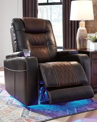Movie nights will be forever changed with the Composer power recliner. The adjustable Easy View™ headrest allows a primo view of the TV no matter how far back you recline and the extended ottoman provides extra room to really stretch out. Ultra-cool lattice stitching elevates the look and ambient LED lighting completes the theater-style experience. So relax, kick off your shoes and enjoy the show.One-touch power control with adjustable positions | Corner-blocked frame with metal reinforced seat | Attached cushions | High-resiliency foam cushions wrapped in thick poly fiber | Easy View™ power adjustable headrest | Includes USB charging port in the power control | Extended ottoman for enhanced comfort | Ambient blue LED lighting on cup holders and base for a theater-style experience | Polyester/polyurethane upholstery | Power cord included; UL Listed | Estimated Assembly Time: 15 Minutes
