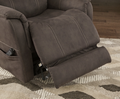 Take charge of your seating with the Ballister power lift recliner. Its easy power button motion control allows you the full spectrum of comfort—from a gentle lift-and-tilt for standing up to a lay flat design ideal for an afternoon snooze. Not much gets past the power adjustable headrest and lumbar support, or even the independent motor controls to get that just right position. You’ll always stay connected with the included USB charging port in the power control, and relish in the hours of versatile support that never stops giving.One-touch (hand control) power button with adjustable positions | Easy View™ power adjustable headrest and power lumbar support | Corner-blocked frame with metal reinforced seat | Attached back and seat cushions | High-resiliency foam cushions wrapped in thick poly fiber | Side pocket storage | Includes USB charging port in the power control | Dual motors control the footrest and back independently for custom comfort positioning | Lay flat design for extended naptime comfort | Polyester upholstery | Compatible with emergency battery backup (sold separately), in case of power outage | Power cord included; UL Listed | Estimated Assembly Time: 15 Minutes