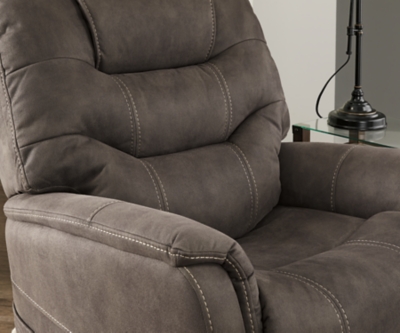 Take charge of your seating with the Ballister power lift recliner. Its easy power button motion control allows you the full spectrum of comfort—from a gentle lift-and-tilt for standing up to a lay flat design ideal for an afternoon snooze. Not much gets past the power adjustable headrest and lumbar support, or even the independent motor controls to get that just right position. You’ll always stay connected with the included USB charging port in the power control, and relish in the hours of versatile support that never stops giving.One-touch (hand control) power button with adjustable positions | Easy View™ power adjustable headrest and power lumbar support | Corner-blocked frame with metal reinforced seat | Attached back and seat cushions | High-resiliency foam cushions wrapped in thick poly fiber | Side pocket storage | Includes USB charging port in the power control | Dual motors control the footrest and back independently for custom comfort positioning | Lay flat design for extended naptime comfort | Polyester upholstery | Compatible with emergency battery backup (sold separately), in case of power outage | Power cord included; UL Listed | Estimated Assembly Time: 15 Minutes