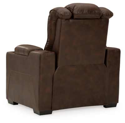 When it comes to style, you’ve got game. Rest assured, the Owner’s Box power recliner is sure to win you over with its ultra-cool looks and major league features. Showcasing all the bells and whistles, this designer recliner is inspired by sports car interiors—with a fabulous faux leather accentuated with horizontal channel tufting. An advanced one-touch power control with an Easy View™ power headrest puts you in the driver’s seat. Dual cup holders and armrests with hidden storage take the form and function to another level.One-touch power control with adjustable positions | Easy View™ adjustable headrest | Corner-blocked frame with metal reinforced seat | Attached cushions | High-resiliency foam cushions wrapped in thick poly fiber | Faux leather upholstery | Each armrest includes storage compartment and cup holder | Extended ottoman for enhanced comfort | Power cord included; UL Listed | Exposed feet with faux wood finish | Estimated Assembly Time: 15 Minutes