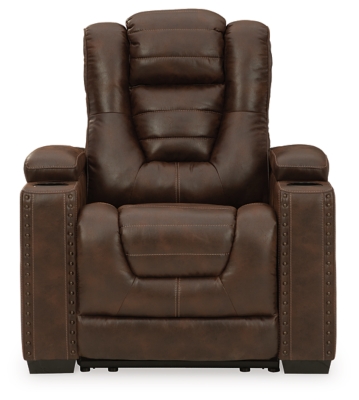 When it comes to style, you’ve got game. Rest assured, the Owner’s Box power recliner is sure to win you over with its ultra-cool looks and major league features. Showcasing all the bells and whistles, this designer recliner is inspired by sports car interiors—with a fabulous faux leather accentuated with horizontal channel tufting. An advanced one-touch power control with an Easy View™ power headrest puts you in the driver’s seat. Dual cup holders and armrests with hidden storage take the form and function to another level.One-touch power control with adjustable positions | Easy View™ adjustable headrest | Corner-blocked frame with metal reinforced seat | Attached cushions | High-resiliency foam cushions wrapped in thick poly fiber | Faux leather upholstery | Each armrest includes storage compartment and cup holder | Extended ottoman for enhanced comfort | Power cord included; UL Listed | Exposed feet with faux wood finish | Estimated Assembly Time: 15 Minutes