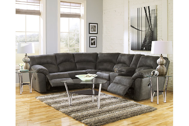 With plush cushions and wraparound pillow top arms, the Tambo sectional takes comfort to a whole new level. Faux vintage leather requires minimal care, making this relaxation station ideal in homes with children and pets. Reclining feature engages with the pull of a tab, putting pleasure at your fingertips.Includes 2 pieces: left-arm facing reclining loveseat and right-arm facing reclining loveseat | "Left-arm" and "right-arm" describe the position of the arm when you face the piece | Pull tab reclining motion | Dual-sided recliners; right-arm facing loveseat with center storage console and 2 cup holders | Corner-blocked frame with metal reinforced seats | High-resiliency foam cushions wrapped in thick poly fiber | Polyester/polyurethane upholstery | Estimated Assembly Time: 5 Minutes