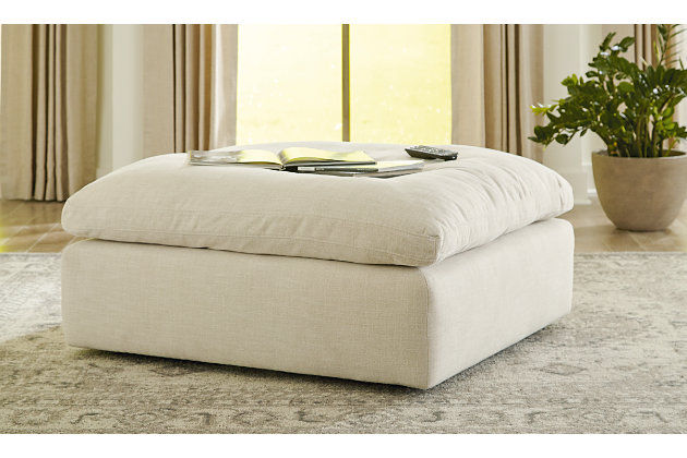 Blending a fresh, clean aesthetic with cloud-like comfort that’s impossible to resist, the Tanavi ottoman sets the scene for living the dream. Whether your look is warm and cozy modern farmhouse or cool, crisp and contemporary, this masterfully crafted square ottoman tantalizes with a feather/fiber blend cushion with pillowy plushness and a linen-like fabric that’s a breath of fresh air.Corner-blocked frame | Attached cushioned top | Cushion with feather/fiber blend encasing a foam core | Polyester upholstery | Perfect for a modern farmhouse or contemorary aesthetic