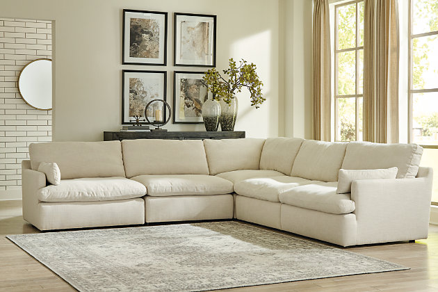 Blending a fresh, clean aesthetic with cloud-like comfort that’s impossible to resist, the Tanavi sectional sets the scene for living the dream. Whether your look is warm and cozy modern farmhouse or cool, crisp and contemporary, this masterfully crafted modular sectional tantalizes with feather/fiber blend reversible cushions with pillowy plushness and a linen-like fabric that’s a breath of fresh air. Slim track arms and structural bolster pillows enhance the experience.Includes 5 pieces: 2 armless chairs, left-arm facing corner chair, right-arm facing corner chair and wedge | "Left-arm" and "right-arm" describe the position of the arm when you face the piece | Corner-blocked frame | Reversible seat/back cushions | Seat cushions with feather/fiber blend encasing a foam core | Polyester upholstery | Bolster pillows included | Platform foundation system resists sagging 3x better than spring system after 20,000 testing cycles by providing more even support | Smooth platform foundation maintains tight, wrinkle-free look without dips or sags that can occur over time with sinuous spring foundations | Estimated Assembly Time: 15 Minutes