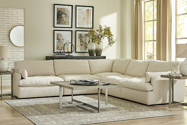 Blending a fresh, clean aesthetic with cloud-like comfort that’s impossible to resist, the Tanavi sectional sets the scene for living the dream. Whether your look is warm and cozy modern farmhouse or cool, crisp and contemporary, this masterfully crafted modular sectional tantalizes with feather-fiber blend reversible cushions with pillowy plushness and a linen-like fabric that’s a breath of fresh air. Slim track arms and structural bolster pillows enhance the experience.Includes 2 armless chairs, left-arm facing corner chair, right-arm facing corner chair and wedge | "Left-arm" and "right-arm" describe the position of the arm when you face the piece | Modular pieces can float anywhere; sides are finished (with no connectors)  | Corner-blocked frame | Reversible seat/back cushions | Seat cushions with feather-fiber blend encasing a foam core | Polyester upholstery | Bolster pillows included | Platform foundation system resists sagging 3x better than spring system after 20,000 testing cycles by providing more even support | Smooth platform foundation maintains tight, wrinkle-free look without dips or sags that can occur over time with sinuous spring foundations | Estimated Assembly Time: 15 Minutes
