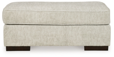 Decidedly modern with a sense of relaxed ease, the Alesandra ottoman looks at home in so many different places and spaces. Sporting a subtle chevron texture, the parchment-tone upholstery takes neutral to new heights. Providing a highly distinctive look: low-to-the-floor block feet in a warm wood-tone finish.Corner-blocked frame | Firmly cushioned | High-resiliency foam cushion wrapped in thick poly fiber | Polyester upholstery | Exposed feet with faux wood finish