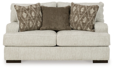 Decidedly modern with a sense of relaxed ease, the Alesandra loveseat looks at home in so many different places and spaces. Providing a highly distinctive look: substantial track arms with curved cornering, wrapped t-cushions and low-to-the-floor block feet in a warm wood-tone finish. Sporting a subtle chevron texture, the parchment-tone upholstery takes neutral to new heights.Corner-blocked frame | Loose back and reversible seat cushions | High-resiliency foam cushions wrapped in thick poly fiber | Polyester upholstery | Throw pillows included | Pillows with soft polyfill | Exposed feet with faux wood finish | Platform foundation system resists sagging 3x better than spring system after 20,000 testing cycles by providing more even support | Smooth platform foundation maintains tight, wrinkle-free look without dips or sags that can occur over time with sinuous spring foundations