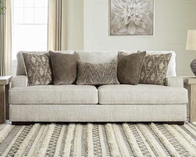 Decidedly modern with a sense of relaxed ease, the Alesandra sofa looks at home in so many different places and spaces. Providing a highly distinctive look: substantial track arms with curved cornering, wrapped t-cushions and low-to-the-floor block feet in a warm wood-tone finish. Sporting a subtle chevron texture, the parchment-tone upholstery takes neutral to new heights.Corner-blocked frame | Reversible back and seat cushions | High-resiliency foam cushions wrapped in thick poly fiber | Polyester upholstery | Throw pillows included | Pillows with soft polyfill | Exposed feet with faux wood finish | Platform foundation system resists sagging 3x better than spring system after 20,000 testing cycles by providing more even support | Smooth platform foundation maintains tight, wrinkle-free look without dips or sags that can occur over time with sinuous spring foundations