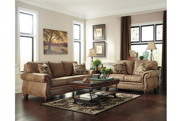 Dramatically transform your living space with the rustic look of weathered leather you love—at a fraction of the cost. That’s the beauty of the Larkinhurst faux leather furniture set with sofa and loveseat. Washed in earthy Southwestern tones, with generous back and seating support and jumbo window-pane stitching—it envelops you in comfort and quality. Classic elements such as roll arms and turned feet bring in just enough traditional touch.Includes sofa and loveseat | Corner-blocked frame | Attached back and loose seat cushions | Cushions with ultra-supportive, pocketed coils | 4 decorative pillows included | Pillows with soft feather inserts; zippered access | Polyester/polyurethane upholstery; polyester/polyurethane and polyester pillows | Nailhead trim | Nailhead trim