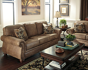 Dramatically transform your living space with the rustic look of weathered leather you love—at a fraction of the cost. That’s the beauty of the Larkinhurst faux leather sofa. Washed in earthy Southwestern tones, with generous back and seating support and jumbo window-pane stitching, it envelops you in comfort and quality. Classic elements such as roll arms and turned feet bring in just enough traditional touch.Corner-blocked frame | Attached back and loose seat cushions | Cushions with ultra-supportive, pocketed coils | 2 decorative pillows included | Pillows with soft feather inserts; zippered access | Polyester/polyurethane upholstery; polyester/polyurethane and polyester pillows | Nailhead trim | Exposed feet with faux wood finish