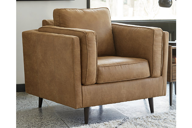 The Maimz chair is mid-century revival done to perfection. Linear and minimalistic, the beautifully edited profile has all the retro elements you love, like sheltering arms, bolster pillows and tapered splayed legs. So casually cool, the caramel faux leather upholstery brings the look right into the present.Corner-blocked frame | Reversible back and seat cushions | High-resiliency foam cushions wrapped in thick poly fiber | Polyester/polyurethane (faux leather) upholstery | Attached arm bolster pillows | Pillows with soft polyfill | Tapered splayed legs | Platform foundation system resists sagging 3x better than spring system after 20,000 testing cycles by providing more even support | Smooth platform foundation maintains tight, wrinkle-free look without dips or sags that can occur over time with sinuous spring foundations