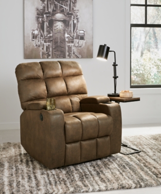 Whether it's Friday movie nights or Sunday afternoon football that moves you, the Kennebec biscuit back power recliner makes it all that much more enticing from the comfort of your abode. Plushly padded in all the right places, rich brown upholstery is pure delight.Brown upholstery | Hidden storage armrest with cup holder | Power reclining mechanism | Power cord included | Estimated Assembly Time: 15 Minutes