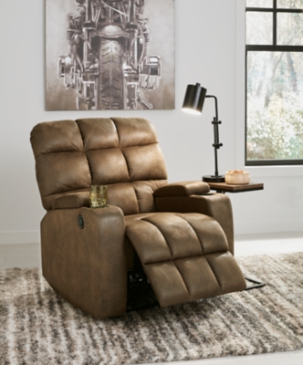 Whether it's Friday movie nights or Sunday afternoon football that moves you, the Kennebec biscuit back power recliner makes it all that much more enticing from the comfort of your abode. Plushly padded in all the right places, rich brown upholstery is pure delight.Brown upholstery | Hidden storage armrest with cup holder | Power reclining mechanism | Power cord included | Estimated Assembly Time: 15 Minutes