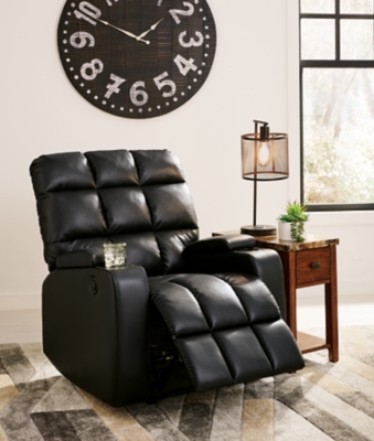 Whether it's Friday movie nights or Sunday afternoon football that moves you, the Kennebec biscuit back power recliner makes it all that much more enticing from the comfort of your abode. Plushly padded in all the right places, striking black upholstery is pure delight.Power recliner | Black upholstery | Power reclining mechanism | Hidden storage armrest with cup holder | Estimated Assembly Time: 15 Minutes