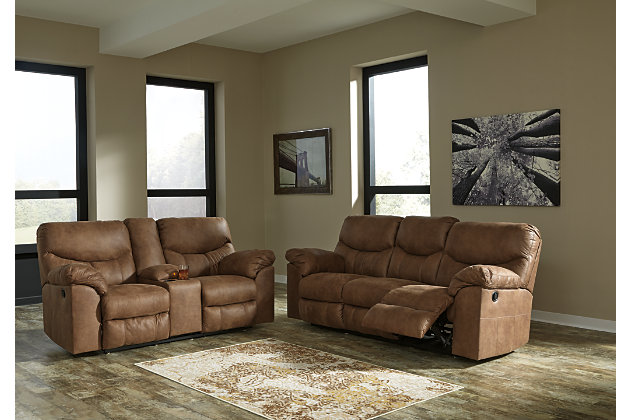 Rock the cool look of leather minus the hefty price tag with the Boxberg reclining sofa. Rich with tonal variation, the indulgently soft upholstery sure looks like the real thing. And talk about indulgent comfort. Double stuffed armrests and sumptuous cushions cradle and support in all the right places. Distinctive scooped stitching enhances this reclining sofa’s contemporary flair.Dual-sided recliner; middle seat remains stationary | Pull tab reclining motion | Corner-blocked frame with metal reinforced seat | Attached cushions | High-resiliency foam cushions wrapped in thick poly fiber | Polyester/polyurethane upholstery | Excluded from promotional discounts and coupons