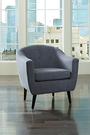With its angular legs, button tufting and tailored flair, Klorey accent chair is clearly inspired by the best in mid-century design. The barrel style is as cool and relevant now as it was then. Textural weave of the upholstery so enriches the neutral hue.High-resiliency foam cushions wrapped in thick poly fiber | Polyester upholstery | Exposed legs with faux wood finish | Corner-blocked frame | Tufted back cushion with loose seat cushion | Excluded from promotional discounts and coupons | Estimated Assembly Time: 30 Minutes