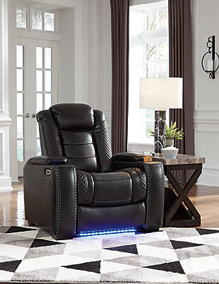 The Party Time power recliner takes its cue from luxury automobiles with lattice- and cross-hatch stitching, for a richly tailored aesthetic that gives you plenty of reasons to celebrate. Sumptuously padded cushions and dramatic midnight black faux leather upholstery add to the indulgence. When it’s time to rev up the action, the recliner’s reclining bucket seat, Easy View™ power adjustable headrest and USB charging port keep you in the driver’s seat.Polyester/polyurethane upholstery | Corner-blocked frame with metal reinforced seat | Attached back and seat cushions | High-resiliency foam cushions wrapped in thick poly fiber | One-touch power control with adjustable positions | Easy View™ power adjustable headrest | Flip up padded armrests with hidden storage | Includes USB charging port in the power control | Ambient blue LED lighting on cup holders and base for a theater-style experience | Power cord included; UL Listed | Estimated Assembly Time: 15 Minutes