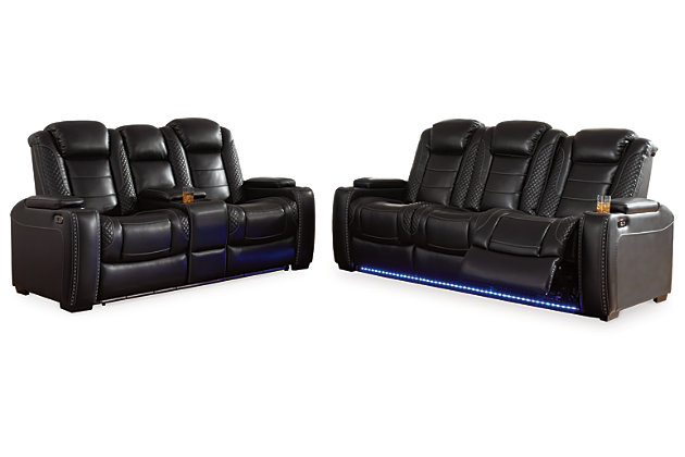 The Party Time power reclining sofa takes its cue from luxury automobiles with lattice- and cross-hatch stitching, for a richly tailored aesthetic that gives you plenty of reasons to celebrate. Sumptuously padded cushions and dramatic midnight black faux leather upholstery add to the indulgence. When it’s time to rev up the action, the sofa’s dual reclining bucket seats (middle seat is stationary), Easy View™ power adjustable headrests and center seat that folds down into a table keep you in the driver’s seat. Dual-sided recliner | One-touch power controls with adjustable positions | Easy View™ power adjustable headrests | Corner-blocked frame with metal reinforced seats | Attached backs and seat cushions | High-resiliency foam cushions wrapped in thick poly fiber | Polyester/polyurethane upholstery | Flip up padded armrests with hidden storage underneath | Drop down table with 2 cup holders and a handy docking station for charging electronics | Includes USB charging port in each power control | Flip up LED light (under center seat headrest) | Ambient blue LED lighting on cup holders and base for a theater-style experience | Power cord included; UL Listed | Estimated Assembly Time: 15 Minutes