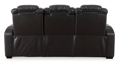 The Party Time power reclining sofa takes its cue from luxury automobiles with lattice- and cross-hatch stitching, for a richly tailored aesthetic that gives you plenty of reasons to celebrate. Sumptuously padded cushions and dramatic midnight black faux leather upholstery add to the indulgence. When it’s time to rev up the action, the sofa’s dual reclining bucket seats (middle seat is stationary), Easy View™ power adjustable headrests and center seat that folds down into a table keep you in the driver’s seat. Dual-sided recliner | One-touch power controls with adjustable positions | Easy View™ power adjustable headrests | Corner-blocked frame with metal reinforced seats | Attached backs and seat cushions | High-resiliency foam cushions wrapped in thick poly fiber | Polyester/polyurethane upholstery | Flip up padded armrests with hidden storage underneath | Drop down table with 2 cup holders and a handy docking station for charging electronics | Includes USB charging port in each power control | Flip up LED light (under center seat headrest) | Ambient blue LED lighting on cup holders and base for a theater-style experience | Power cord included; UL Listed | Estimated Assembly Time: 15 Minutes