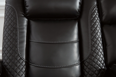 The Party Time power reclining loveseat takes its cue from luxury automobiles with lattice- and cross-hatch stitching, for a richly tailored aesthetic that gives you plenty of reasons to celebrate. Sumptuously padded cushions and dramatic midnight black faux leather upholstery add to the indulgence. When it’s time to rev up the action, the loveseat’s dual reclining bucket seats, Easy View™ power adjustable headrests and center console keep you in the driver’s seat. Dual-sided recliner | One-touch power controls with adjustable positions | Easy View™ power adjustable headrests | Corner-blocked frame with metal reinforced seats | Attached backs and seat cushions | High-resiliency foam cushions wrapped in thick poly fiber | Polyester/polyurethane upholstery | Includes USB charging port in each power control | Flip up padded armrests with hidden storage | Center console with cup holders and underneath storage | Ambient blue LED lighting on cup holders and base for a theater-style experience | Power cord included; UL Listed | Estimated Assembly Time: 15 Minutes