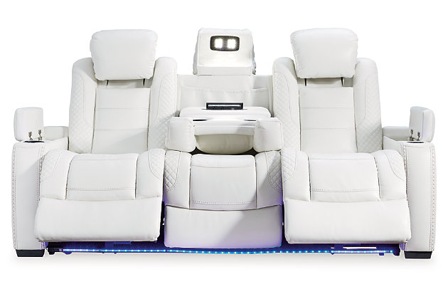 The Party Time power reclining sofa takes its cue from luxury automobiles with lattice and crosshatch stitching, for a richly tailored aesthetic that gives you plenty of reasons to celebrate. Sumptuously padded cushions and crisp white faux leather upholstery add to the indulgence. When it’s time to rev up the action, the dual reclining bucket seats (middle seat stays stationary), Easy View™ power adjustable headrests, LED accent lighting and center seat that folds down into a table keep you in the driver’s seat.Dual-sided recliner | Polyester/polyurethane upholstery | Corner-blocked frame with metal reinforced seat | Attached back and seat cushions | High-resiliency foam cushions wrapped in thick poly fiber | One-touch power control with adjustable positions, Easy View™ adjustable headrest and USB plug-in | LED lighted cup holders; flip up padded armrests with hidden storage | Drop down table with 2 cup holders and a handy docking station for charging electronics | Flip up LED light (under center seat headrest) | Movie theater style base rail LED lighting | Power cord included; UL Listed | Estimated Assembly Time: 15 Minutes