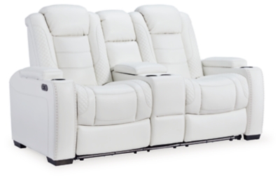 The Party Time power reclining loveseat takes its cue from luxury automobiles with lattice and crosshatch stitching, for a richly tailored aesthetic that gives you plenty of reasons to celebrate. Sumptuously padded cushions and crisp white faux leather upholstery add to the indulgence. When it’s time to rev up the action, the dual reclining bucket seats, Easy View™ power adjustable headrests and center console with docking station keep you in the driver’s seat. Dual-sided recliner | Polyester/polyurethane upholstery | Corner-blocked frame with metal reinforced seat | Attached back and seat cushions | High-resiliency foam cushions wrapped in thick poly fiber | One-touch power control with adjustable positions, Easy View™ adjustable headrest and USB plug-in | Flip up padded armrests with hidden storage | Center console with cup holders and underneath storage | Ambient blue LED lighting on cup holders and base for a theater-style experience | Power cord included; UL Listed | Estimated Assembly Time: 15 Minutes