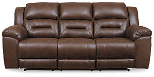 For those that love the cool look of leather but long for the warm feel of fabric, the Stoneland power reclining sofa delivers both with ease. Its high-performance padded faux leather is remarkably durable and easy to clean, just the thing for family spaces. When it’s time to relax, the one-touch power control puts the perfect position at your fingertips. Channel-stitched back cushions provide indulgent lumbar support for maximum seating comfort—not to mention fashion-forward flair.Dual-sided recliner; middle seat remains stationary | Corner-blocked frame with metal reinforced seats | One-touch power control with adjustable positions | Attached cushions | High-resiliency foam cushions wrapped in thick poly fiber | Polyester/polyurethane (faux leather) upholstery | Power cord included; UL Listed | Estimated Assembly Time: 15 Minutes