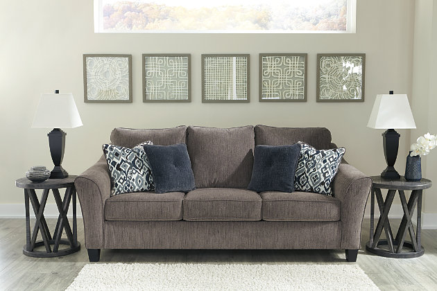 The Nemoli queen sofa sleeper sets the scene for a modern space full of casual flair. Its textured chenille with solid microfiber upholstery provides a luxuriously soft feel that’s inviting. Gently flared arms and plush seat cushions welcome comfort and relaxation. The on-trend slate-colored upholstery offers a perfect background for the four decorative pillows to pop with beauty. Pull-out queen mattress in quality memory foam comfortably accommodates overnight guests.Polyester/textured chenille with solid microfiber upholstery | High-resiliency foam cushions wrapped in thick poly fiber | Corner-blocked frame | Exposed tapered feet | Loose back and seat cushions; non-reversible | Included bi-fold queen memory foam mattress sits atop a supportive steel frame | Memory foam provides better airflow for a cooler night’s sleep | Includes 2 button-tufted pillows and 2 accent pillows made of polyester fabric