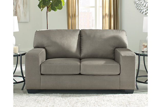 Modern comfort never looked so good. Sporting wide track arms, box cushions and jumbo stitching for high-fashion flair, the Kanosh sofa and loveseat are the ultimate choice in comfortably cool, contemporary style. Indulgent with a suede-like touch and upscale feel, the plush upholstery is the stuff dreams are made of.Includes sofa and loveseat | Corner-blocked frame | Attached back and loose seat cushions | High-resiliency foam cushions wrapped in thick poly fiber | Polyester upholstery | Exposed feet with faux wood finish | Platform foundation system resists sagging 3x better than spring system after 20,000 testing cycles by providing more even support | Smooth platform foundation maintains tight, wrinkle-free look without dips or sags that can occur over time with sinuous spring foundations